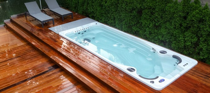 A swim spa installed on a wooden deck.